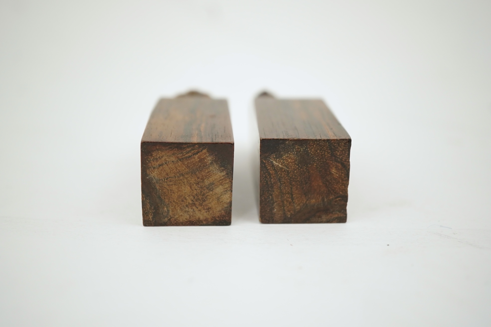 A cased pair of Chinese hardwood ‘lion-dog’ seals, early 20th century